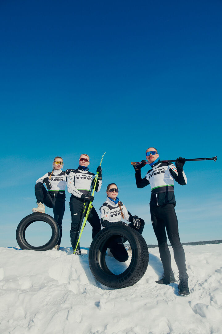 Ski team posing with tyres