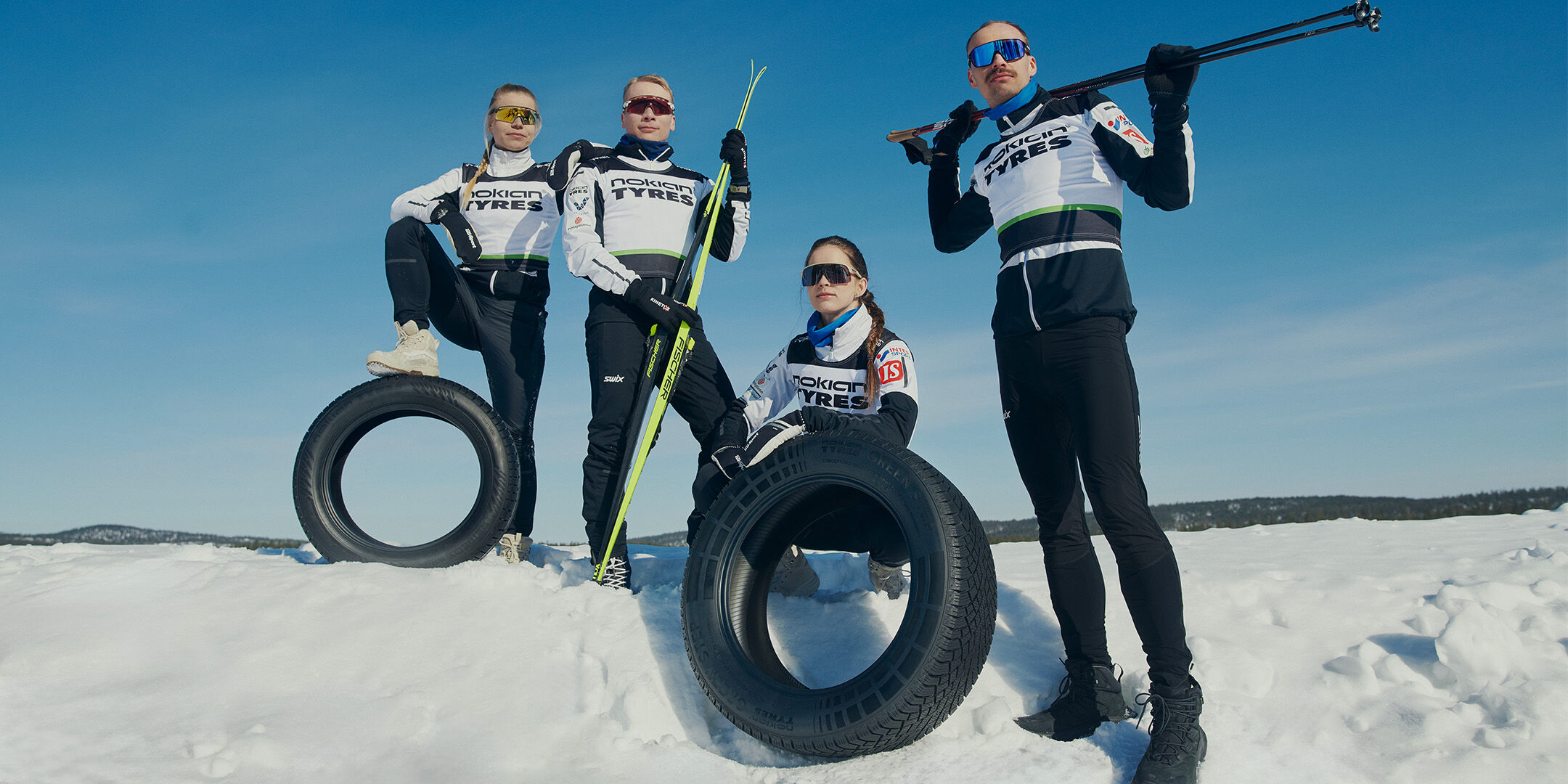 Ski team posing with tyres