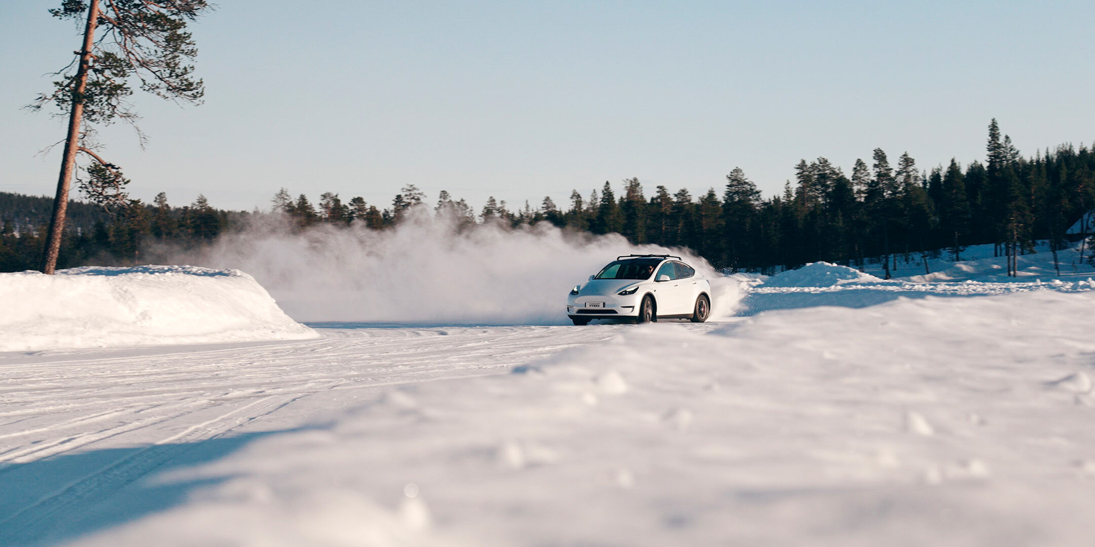 car drifting on a snowy test track