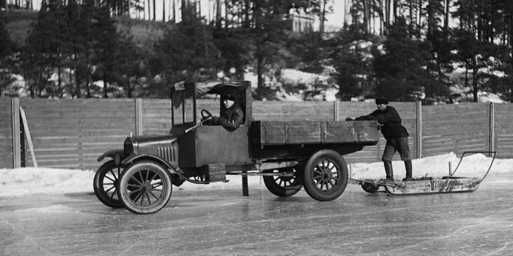 An old timey car on an icy or slippery surface