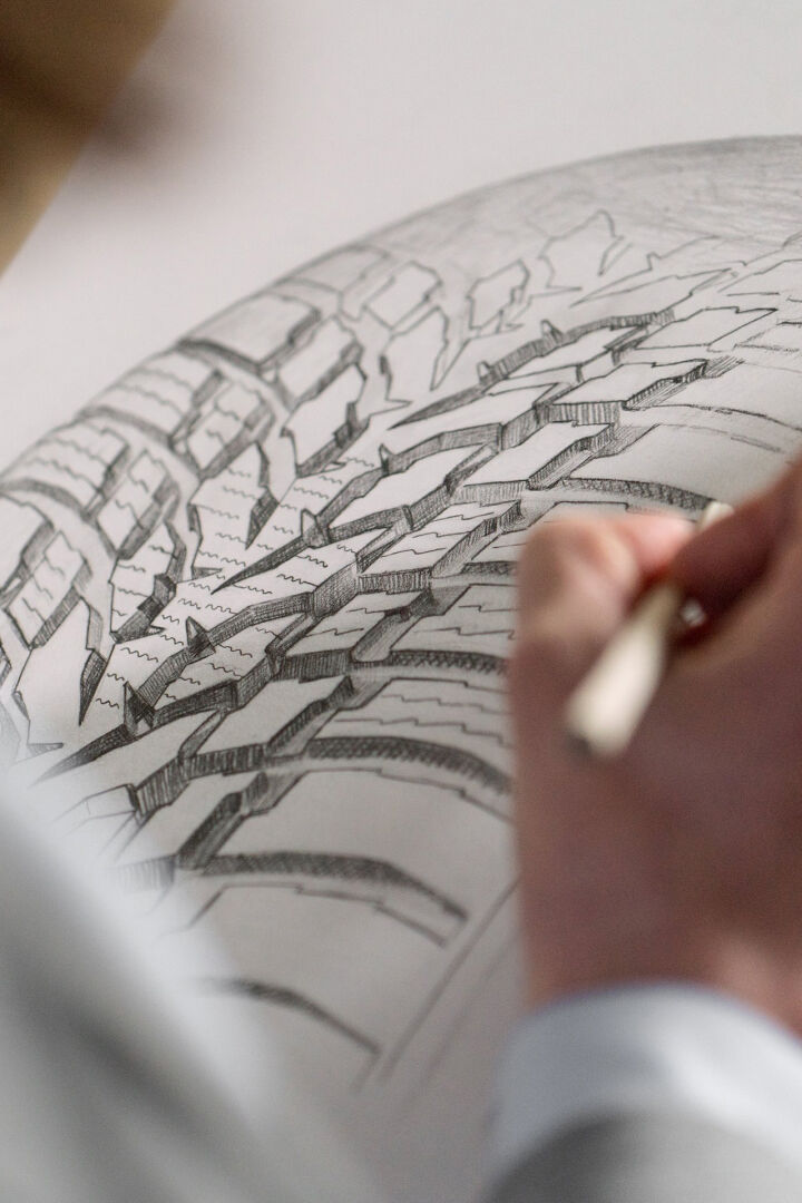 person drawing tire pattern