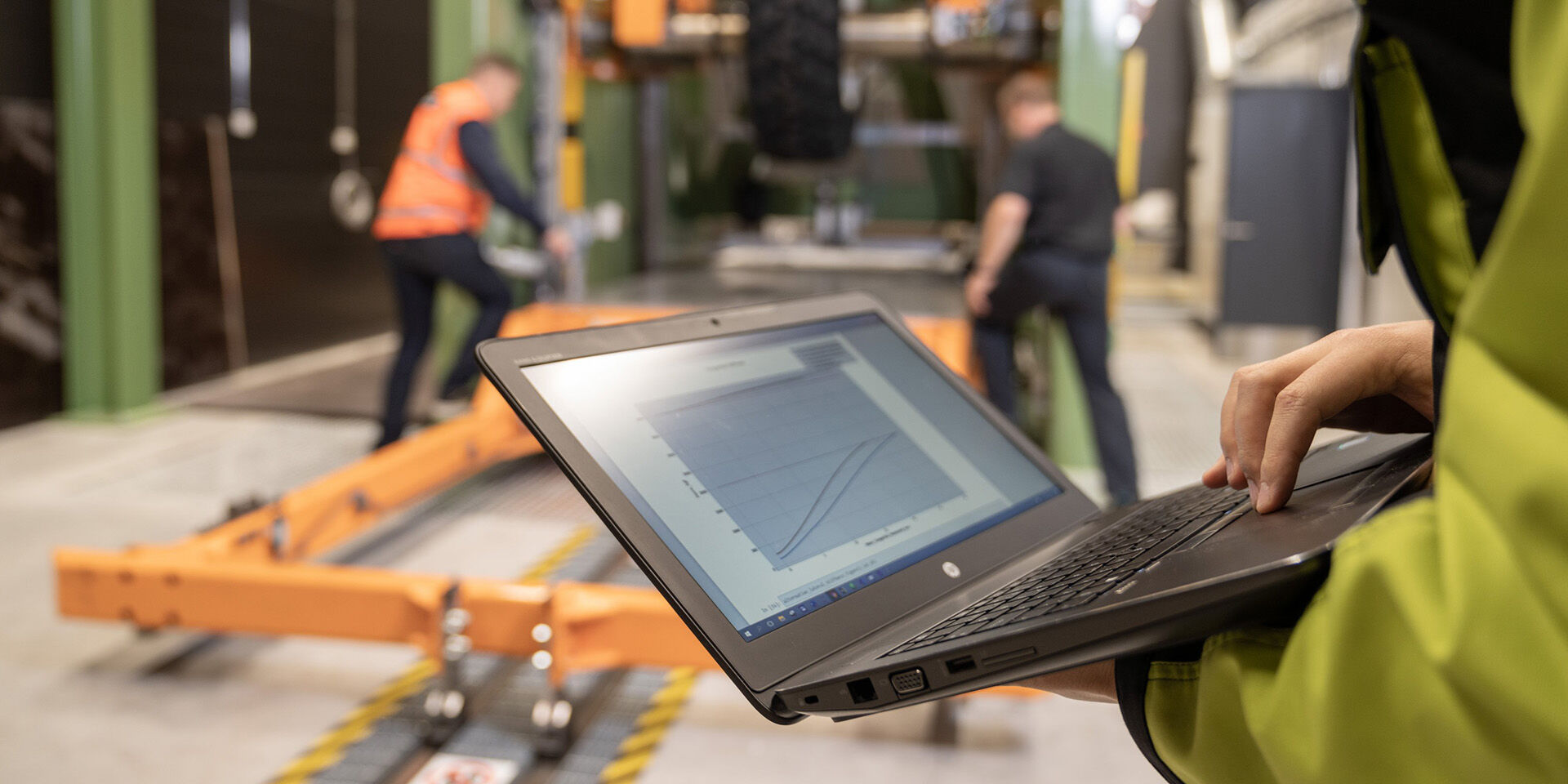 closeup person handling laptop at factory