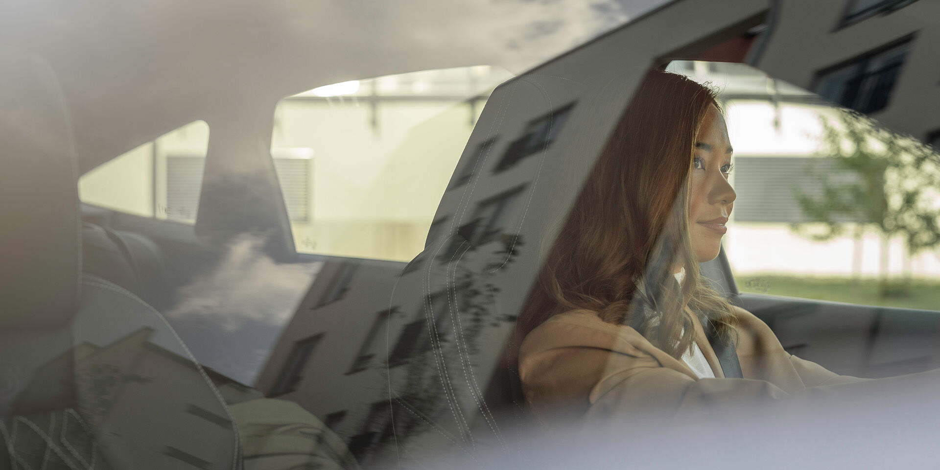 woman driving reflection on window