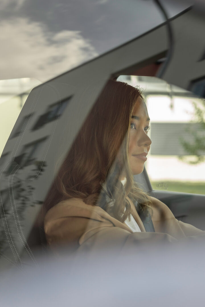 woman driving reflection on window