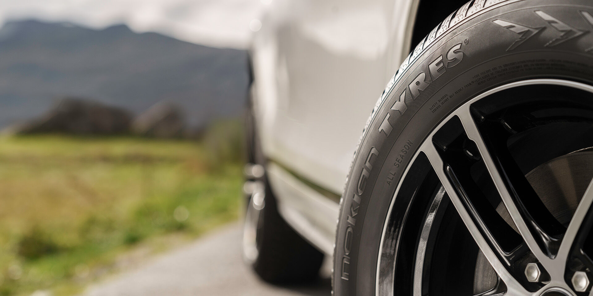 closeup of tire and car on a road