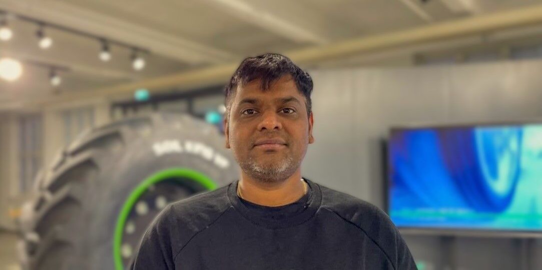 Nokian Tyres employee standing next to a tire