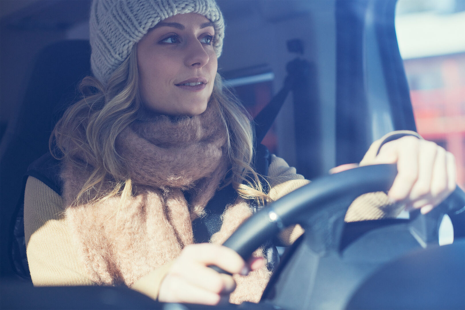 A woman in a car driving
