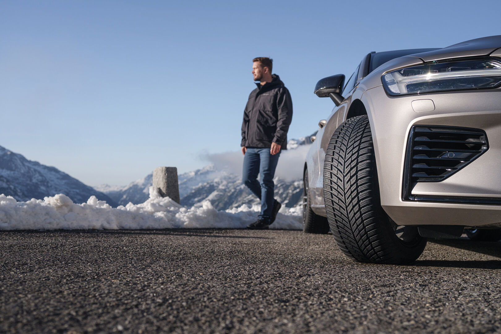 A man with a car with winter tires on