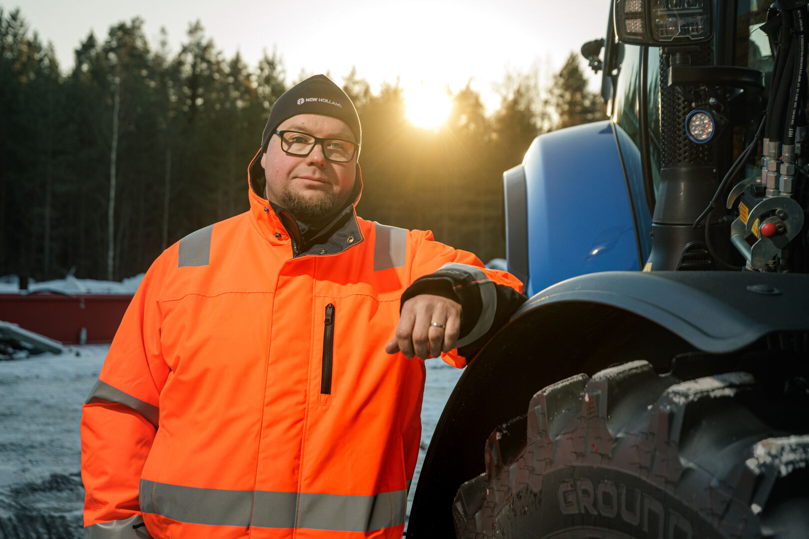 Jarmo Makkonen leaning against a tractor equipped with Nokian Tyres Ground King tires.