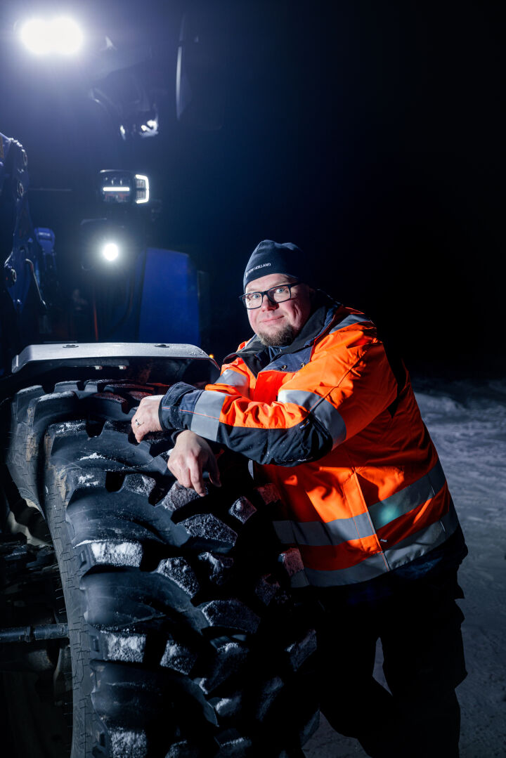 Jarmo Makkonen leaning on a Nokian Tyres Ground King tire mounted on a tractor.